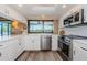 Well-lit kitchen featuring stainless steel appliances, white cabinetry, and scenic outdoor views, offering functionality and style at 671 Tallahassee Ne Dr, St Petersburg, FL 33702