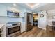 Well-equipped kitchen with stainless steel appliances and wood floors, seamlessly connecting to the dining area, perfect for entertaining at 671 Tallahassee Ne Dr, St Petersburg, FL 33702