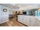 Open-concept layout seamlessly connects the kitchen, dining area, and living room with contemporary finishes at 671 Tallahassee Ne Dr, St Petersburg, FL 33702