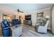 Spacious living room featuring hardwood floors, comfortable seating, and a large entertainment center at 671 Tallahassee Ne Dr, St Petersburg, FL 33702
