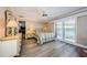 Serene main bedroom with a ceiling fan, hardwood floors, and access to the outdoors at 671 Tallahassee Ne Dr, St Petersburg, FL 33702