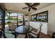 Relaxing screened-in patio with ceiling fan, lighting, and adjacent outdoor kitchen at 671 Tallahassee Ne Dr, St Petersburg, FL 33702