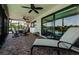 Relaxing covered patio with brick flooring and lounge seating near the pool at 671 Tallahassee Ne Dr, St Petersburg, FL 33702