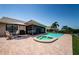 An outdoor pool and spa are framed by a brick patio, with seating and a screened in porch, perfect for outdoor living at 671 Tallahassee Ne Dr, St Petersburg, FL 33702