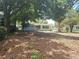 Green backyard with trees, view of the home at 6731 Old Main St, New Port Richey, FL 34653