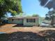 View of the backyard with mature trees and green grass at 6731 Old Main St, New Port Richey, FL 34653