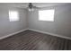 Bedroom featuring ceiling fan and two windows at 6731 Old Main St, New Port Richey, FL 34653