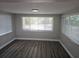 View of the living room with flooring and large windows at 6731 Old Main St, New Port Richey, FL 34653