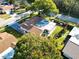 Aerial view showcasing the property's layout, including a sunroom, fenced yard, and driveway at 700 Bowsprit Pl, Palm Harbor, FL 34685