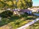 Aerial view of home showcasing the landscaped front yard, mature trees, and the surrounding neighborhood at 700 Bowsprit Pl, Palm Harbor, FL 34685