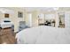 Spacious bedroom with hardwood floors, comfortable chair, and open doorway to another room at 700 Bowsprit Pl, Palm Harbor, FL 34685