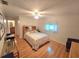 Cozy bedroom features wood floors, large window, and a charming quilt on the bed at 700 Bowsprit Pl, Palm Harbor, FL 34685