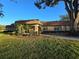 Exterior view showcasing a well-maintained building with landscaping, and mature trees at 700 Bowsprit Pl, Palm Harbor, FL 34685