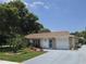 Charming single-story home featuring mature trees, manicured landscaping, and a well-maintained lawn at 700 Bowsprit Pl, Palm Harbor, FL 34685
