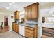 Open kitchen featuring tile backsplash, granite countertops and wood cabinets at 700 Bowsprit Pl, Palm Harbor, FL 34685