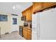 Bright kitchen features stainless appliances, wooden cabinetry, and tile floors at 700 Bowsprit Pl, Palm Harbor, FL 34685