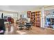 Comfortable living room with hardwood floors, bookshelf, and sliding glass doors at 700 Bowsprit Pl, Palm Harbor, FL 34685