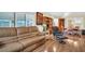 Cozy living room with hardwood floors, comfortable seating, and access to sunroom at 700 Bowsprit Pl, Palm Harbor, FL 34685
