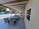 Covered outdoor patio area with tables and chairs offers a comfortable place to unwind near the pool at 700 Bowsprit Pl, Palm Harbor, FL 34685