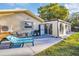 Outdoor patio area featuring a lounge chair, patio furniture, grill, and a sun room at 700 Bowsprit Pl, Palm Harbor, FL 34685