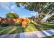 Well-maintained yard with lawn, mature trees, privacy fence, and view of the side of the home at 700 Bowsprit Pl, Palm Harbor, FL 34685
