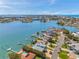 This aerial view showcases a waterfront home and the surrounding bay and neighborhood at 7115 Bay St, St Pete Beach, FL 33706
