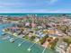 Aerial view of a coastal community with waterfront homes, docks, and a glimpse of the ocean at 7115 Bay St, St Pete Beach, FL 33706