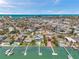 Beautiful aerial view of waterfront homes, with docks on the water and the city in the distance at 7115 Bay St, St Pete Beach, FL 33706