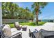 Inviting backyard patio area with comfortable seating, perfect for relaxing and enjoying the waterfront view at 7115 Bay St, St Pete Beach, FL 33706