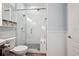 Bright bathroom featuring modern fixtures, toilet, and stand up shower at 7115 Bay St, St Pete Beach, FL 33706