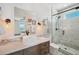 Elegant bathroom featuring marble stand up shower and custom vanity at 7115 Bay St, St Pete Beach, FL 33706