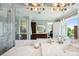 Large bathroom mirror view featuring dual vanities, standalone tub, and a luxurious glass shower at 7115 Bay St, St Pete Beach, FL 33706