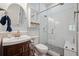 Bathroom with a vessel sink, subway tile shower with glass door, and updated fixtures at 7115 Bay St, St Pete Beach, FL 33706