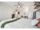 Well lit bedroom featuring water views, ceiling fan and crisp white linen at 7115 Bay St, St Pete Beach, FL 33706