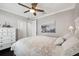 Bedroom featuring dark hardwood floors, dresser, fan and black and white painting of Paris at 7115 Bay St, St Pete Beach, FL 33706