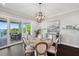 Dining room features a round table, chandelier, and sliding glass doors to the patio at 7115 Bay St, St Pete Beach, FL 33706