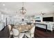 Open floorplan featuring a dining room, kitchen, and living room with a fireplace at 7115 Bay St, St Pete Beach, FL 33706
