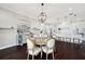 Dining area showcases a round table with seating, chandelier, and modern decor at 7115 Bay St, St Pete Beach, FL 33706