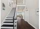 Open foyer with staircase, dark wood floors, and views of the living area at 7115 Bay St, St Pete Beach, FL 33706