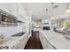 Beautiful kitchen boasting marble countertops, stainless steel appliances, and seamless access to the living room at 7115 Bay St, St Pete Beach, FL 33706