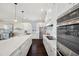 Modern kitchen featuring stainless steel appliances, white cabinets, marble countertops, and a sleek design at 7115 Bay St, St Pete Beach, FL 33706