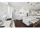 Bright kitchen features a marble countertop island with seating and dark wood flooring at 7115 Bay St, St Pete Beach, FL 33706