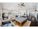 Open living room featuring hardwood floors, neutral colors, and a smooth transition to the gourmet kitchen at 7115 Bay St, St Pete Beach, FL 33706