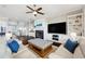 Cozy living room with fireplace, white sofas, ceiling fan and custom built-ins at 7115 Bay St, St Pete Beach, FL 33706