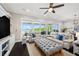 Inviting living room showcasing water views, plush seating, and custom built-in cabinets for storage at 7115 Bay St, St Pete Beach, FL 33706