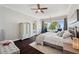 Light and airy main bedroom featuring hardwood floors, water views, and an en-suite bathroom at 7115 Bay St, St Pete Beach, FL 33706