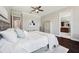 Stylish main bedroom with wood floors, soft lighting, and access to the en-suite bathroom at 7115 Bay St, St Pete Beach, FL 33706