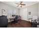 Bright home office with hardwood floors, neutral paint, a ceiling fan, and a large window at 7115 Bay St, St Pete Beach, FL 33706