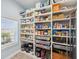 Organized walk-in pantry with custom shelving and storage containers, and a window at 7115 Bay St, St Pete Beach, FL 33706