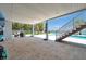 Open patio with staircase leading to the backyard pool and lounging area at 7115 Bay St, St Pete Beach, FL 33706